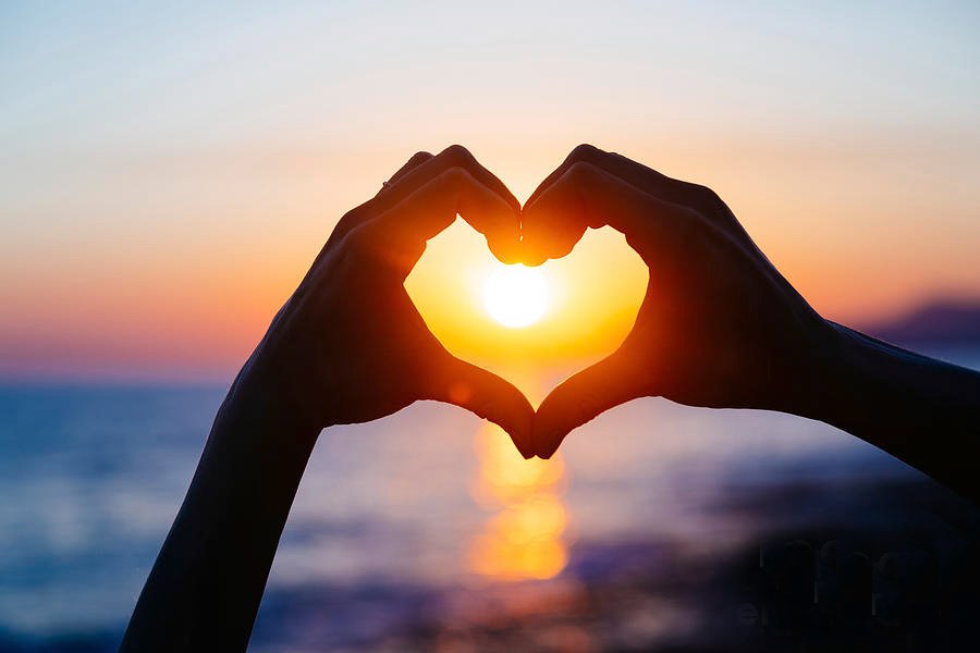 hands-forming-a-heart-shape-with-sunset-teraphim